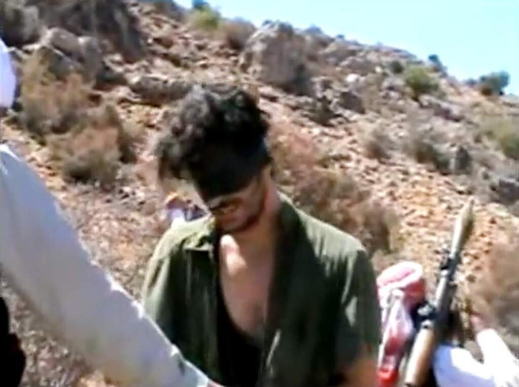 An taken from undated video posted to YouTube of American freelance journalist Austin Tice, who was taken hostage in Syria in 2012 and has been missing since.