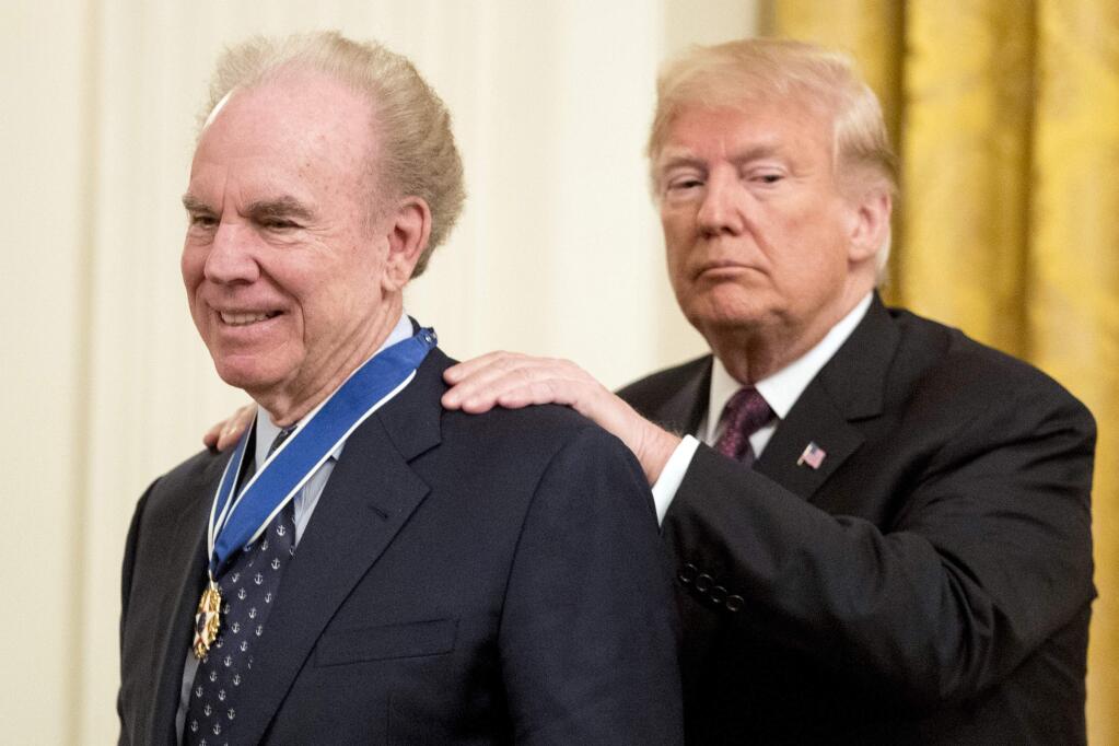 President Donald Trump awards former professional football player Roger Staubach the Medal of Freedom during a ceremony in the East Room of the White House in Washington, Friday, Nov. 16, 2018. (AP Photo/Andrew Harnik)