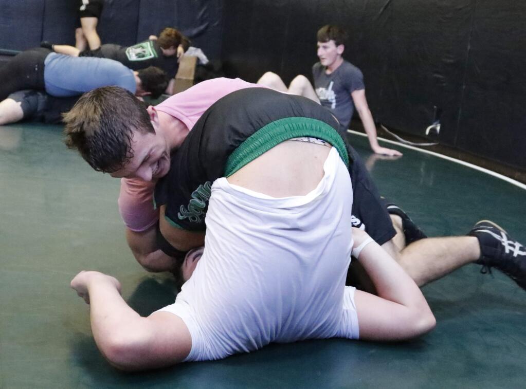 Bill Hoban/Special to the Index-TribuneLawson Lee gets Hank Schoeningh in a cradle move during Sonoma Valley High wrestling practice Wednesday. Lee and Schoeningh are two of eight returning North Coast Section qualifiers returning to this years Dragon squad.