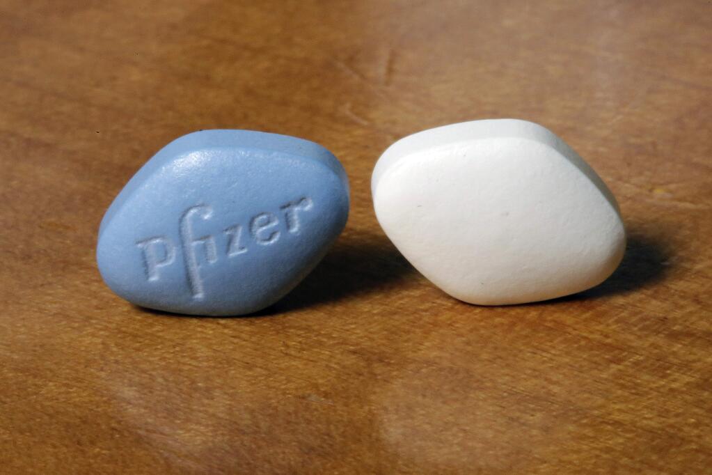 This Monday, Dec. 4, 2017 photo shows a tablet of Pfizer's Viagra, left, and the company's generic version, sildenafil citrate, at Pfizer Inc., headquarters in New York. The drugmaker is launching its own cheaper generic version of Viagra rather than lose sales when its impotence pill gets its first generic competition. (AP Photo/Richard Drew)