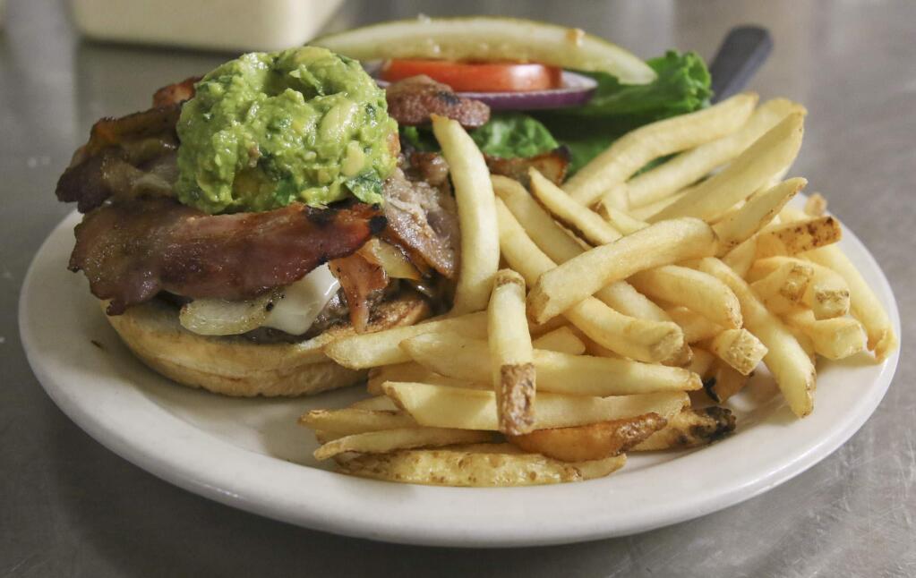 A burger with guacamole and bacon at McNear's Saloon & Dining House on Monday June 1, 2015. (SCOTT MANCHESTER/ARGUS-COURIER STAFF)