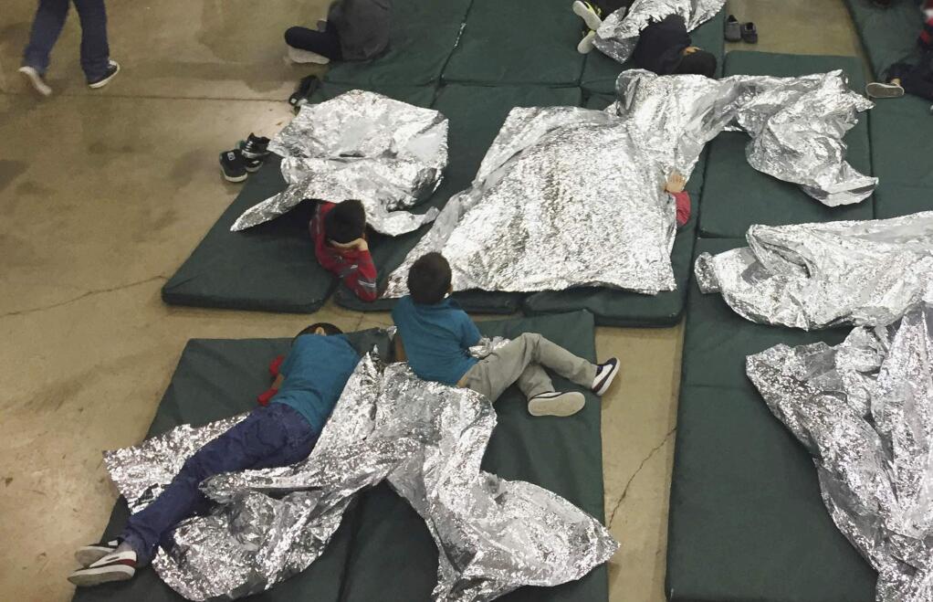 FILE - In this Sunday, June 17, 2018, file photo provided by U.S. Customs and Border Protection, people who've been taken into custody related to cases of illegal entry into the United States rest in one of the cages at a facility in McAllen, Texas. Immigrant children described hunger, cold and fear in a voluminous court filing about the facilities where they were held in the days after crossing the border. Advocates fanned out across the southwest to interview more than 200 immigrant parents and children about conditions in U.S. holding facilities, detention centers and a youth shelter. The accounts form part of a case over whether the government is complying with a longstanding settlement over the treatment of immigrant youth in custody. (U.S. Customs and Border Protection's Rio Grande Valley Sector via AP, File)