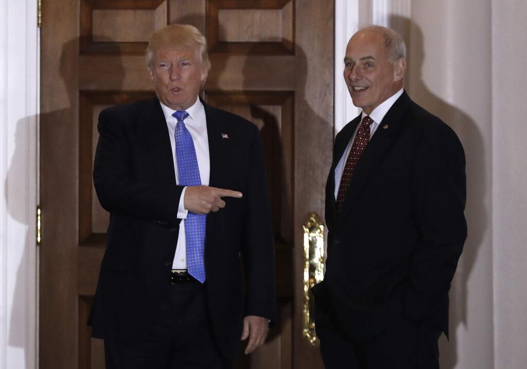 FILE - In this Nov. 20, 2016 file photo, President-elect Donald Trump talks to media as he stands with retired Marine Gen. John Kelly, at the Trump National Golf Club Bedminster clubhouse in Bedminster, N.J. Trump is tapping another four-star military officer for his administration. He has picked Kelly to lead the Homeland Security Department, according to people close to the transition. (AP Photo/Carolyn Kaster, File)