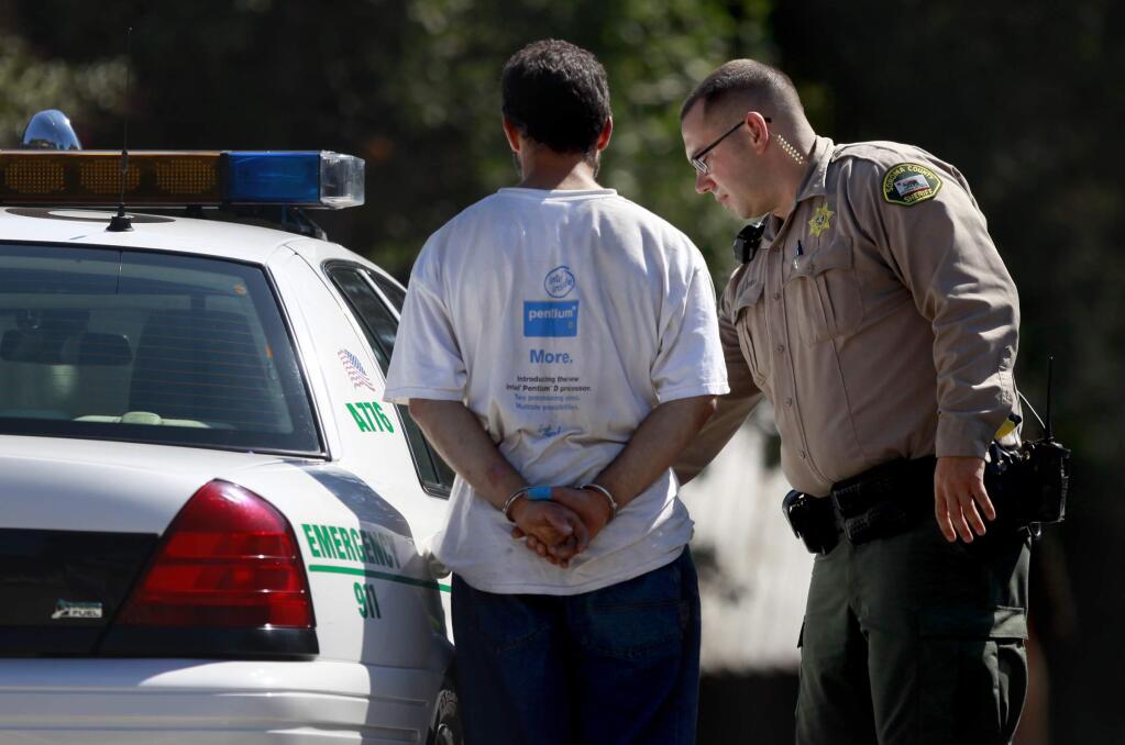 Sonoma County sheriff's deputies arrested a young man near a home in the 9000 block of Starr Road while a search continued for other suspects in Windsor on Thursday, Aug. 28, 2014. (BETH SCHLANKER / The Press Democrat)