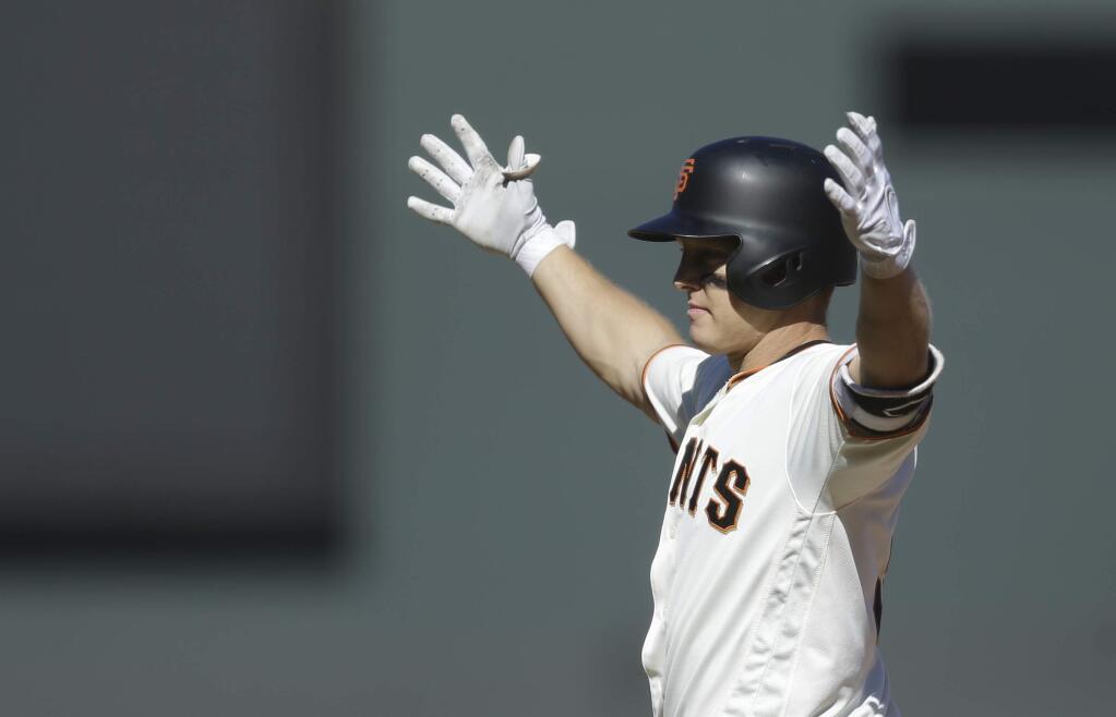 San Francisco Giants catcher Nick Hundley celebrates after making the game winning hit in the twelfth inning of a baseball game against the San Diego Padres, Saturday, July 22, 2017, in San Francisco. (AP Photo/Ben Margot)