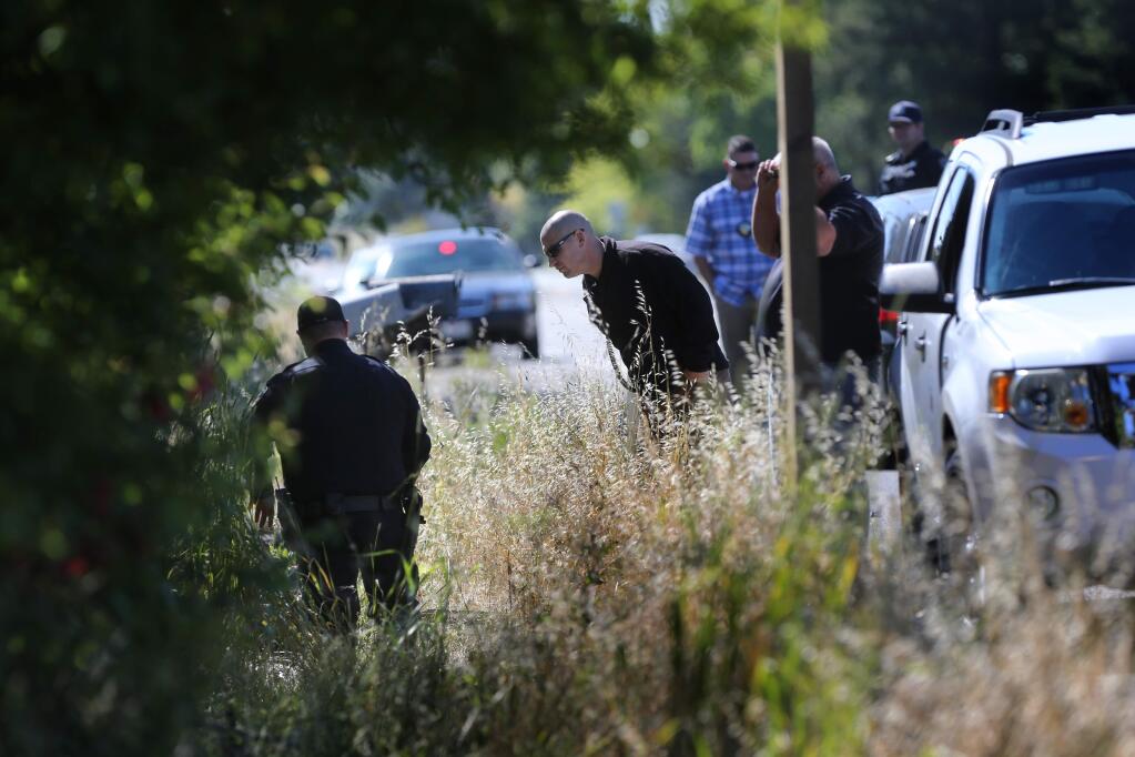 Petaluma police officers investigate the scene of a fatal motorcycle accident near 3765 Lakeville Hwy in Petaluma, California on Tuesday, May 28, 2019. (BETH SCHLANKER/The Press Democrat)