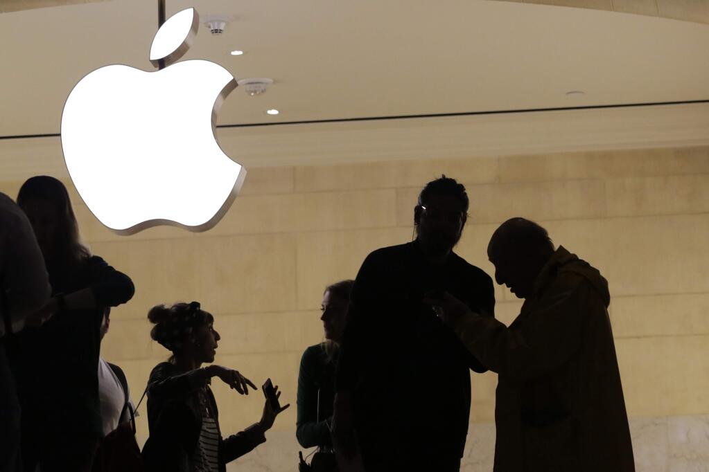 FILE- In this May 31, 2018, file photo customers enter the Apple store in New York. The Supreme Court is allowing consumers to pursue an antitrust lawsuit that claims Apple has unfairly monopolized the market for the sale of iPhone apps. (AP Photo/Mark Lennihan, File)