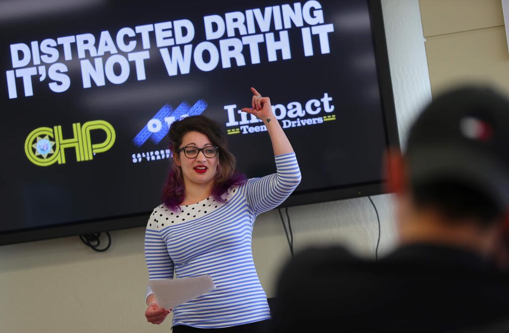 Maria Coyner, who struck and killed a pedestrian while texting and driving in 2012, speaks to a group of teenage drivers at Sonoma Raceway, during an Impact Teen Drivers presentation on Wednesday, April 5, 2017. (Christopher Chung/ The Press Democrat)