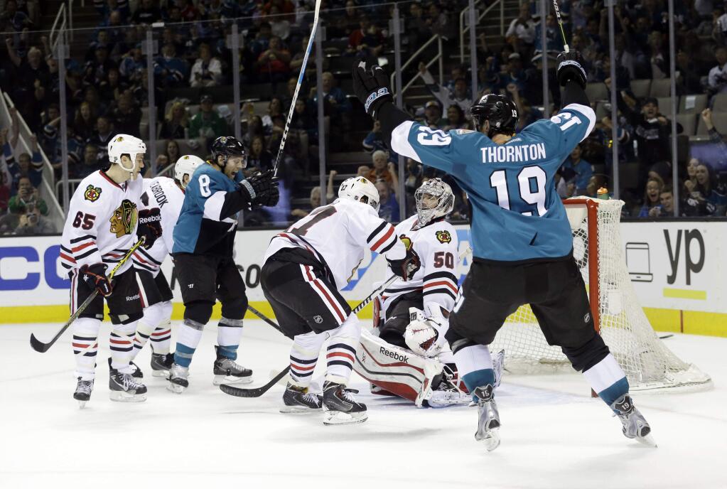 San Jose Sharks' Joe Thornton (19) and Joe Pavelski (8) celebrate a goal by teammate Melker Karlsson (not shown) during the first period of a game against the Chicago Blackhawks, Saturday, March 14, 2015, in San Jose. (AP Photo/Marcio Jose Sanchez)