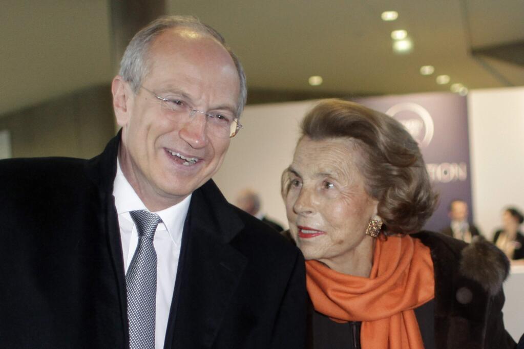 FILE - In this Thursday March 3, 2011 file photo, L'Oreal heiress Liliane Bettencourt, right, and L'Oreal new chief executive Jean-Paul Agon arrive at the L'Oreal-UNESCO prize for the women in science, in Paris, France. L'Oreal cosmetics heiress Liliane Bettencourt has died at the age of 94 at her home, her family announced. (AP Photo/Thibault Camus, File)