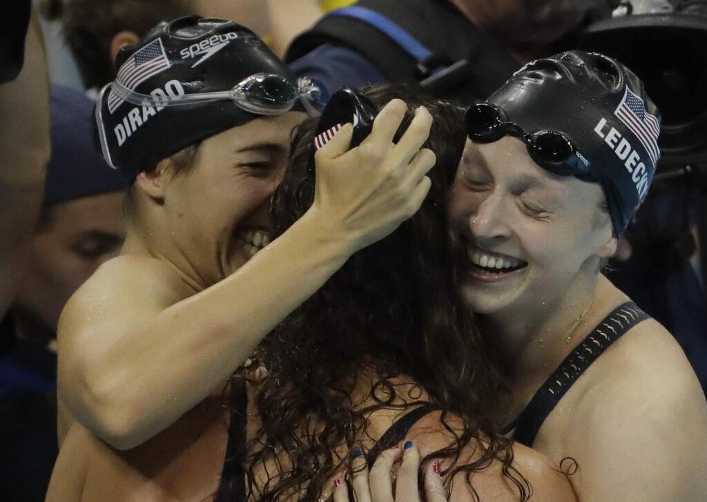United States' Maya DiRado, left, Allison Schmitt, and Katie Ledecky, right, celebrate winning the gold in the women's 4x200-meter freestyle relay during the swimming competitions at the 2016 Summer Olympics, Thursday, Aug. 11, 2016, in Rio de Janeiro, Brazil. (AP Photo/Matt Slocum)