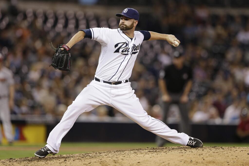 FILE - In this Sept. 25, 2015, file photo, San Diego Padres relief pitcher Marc Rzepczynski works against an Arizona Diamondbacks batter during the ninth inning of a baseball game, in San Diego. A person with knowledge of the deal says the San Diego Padres have traded first baseman Yonder Alonso and reliever Marc Rzepczynski to the Oakland A's for left-hander Drew Pomeranz and minor league pitcher Jose Torres, plus either a player to be named or cash. The person spoke with The Associated Press on Wednesday, Dec. 2, 2015, on condition of anonymity because the trade hadn't been announced. (AP Photo/Gregory Bull, File)