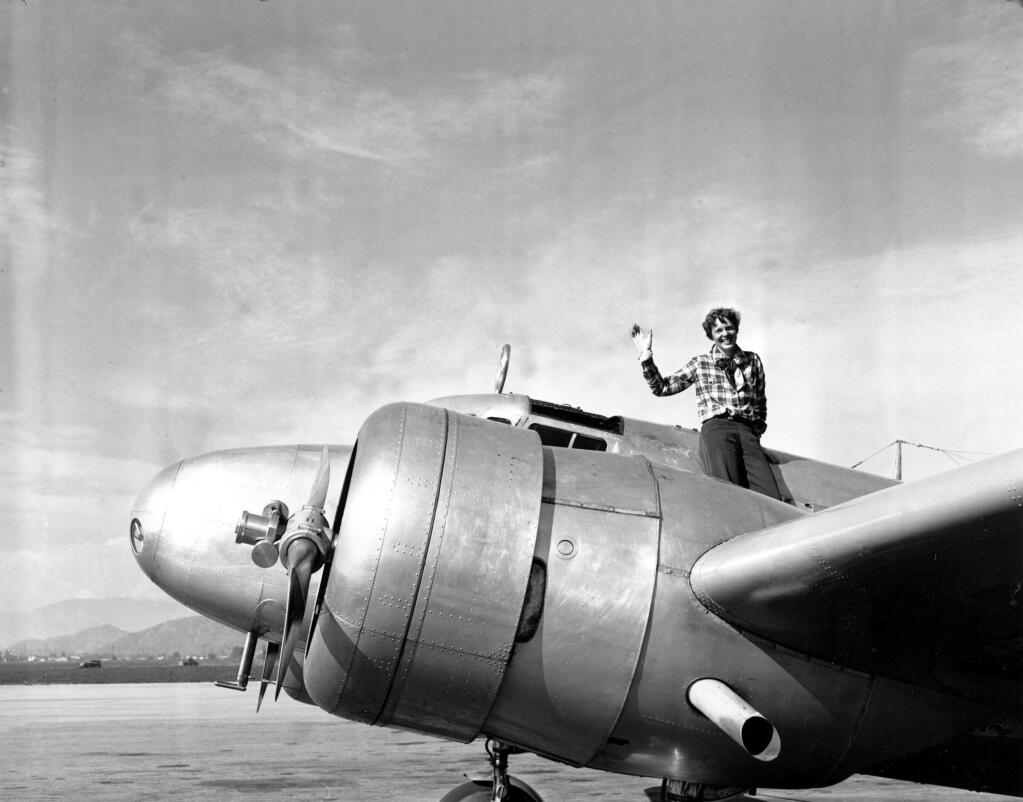 FILE - In a March 10, 1937 file photo American aviatrix Amelia Earhart waves from the Electra before taking off from Los Angeles, Ca., on March 10, 1937. Earhart is flying to Oakland, Ca., where she and her crew will begin their round-the-world flight to Howland Island on March 18. (AP Photo, file)