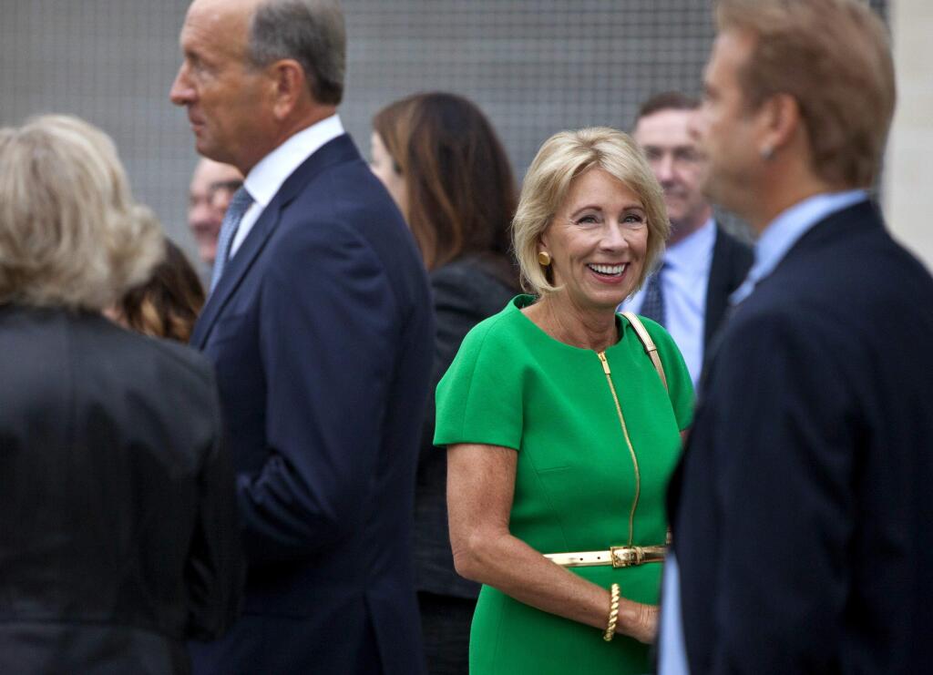 U.S. Education Secretary Betsy DeVos arrives at the dedication ceremony of Michigan State University's new Grand Rapids Medical Research Center on Wednesday, Sept. 20, 2017, in Grand Rapids, Mich. (Cory Morse /The Grand Rapids Press via AP)