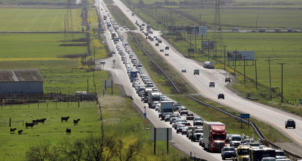 Traffic backs up along eastbound Highway 37 near Lakeville Highway on Monday, April 2, 2018. (Kent Porter/ The Press Democrat)