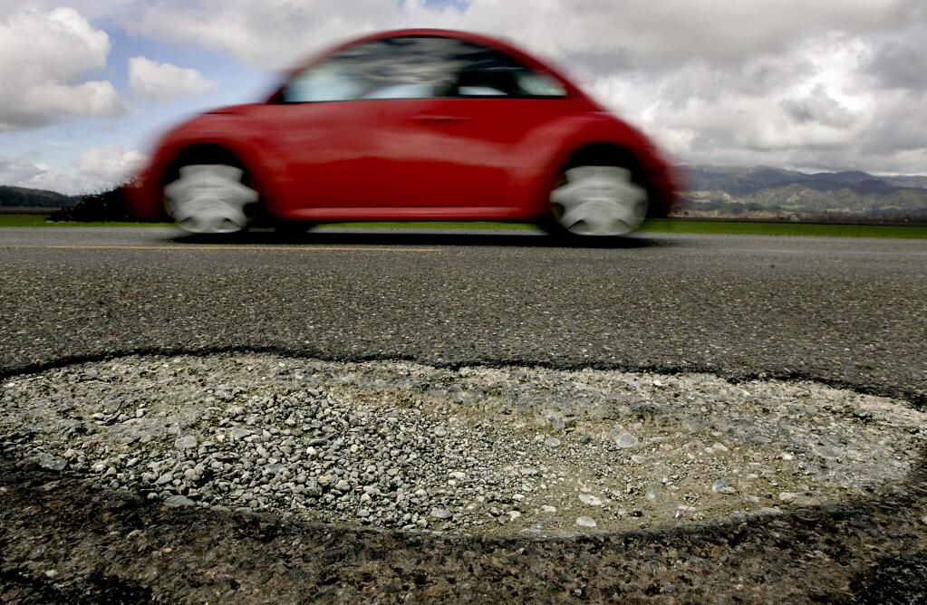 A pothole on Lytton Station Road, east of Highway 101 in 2010. (KENT PORTER/ PD FILE)