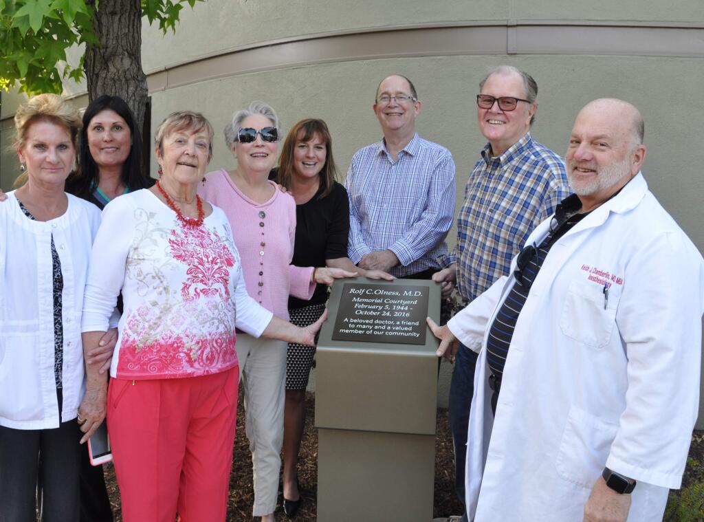 Sonoma Valley Hospital on May 18, dedicated the Rolf C. Olness, MD, Memorial Courtyard at the hospital. LeeJay Olness, along with Dr. Olness' sister, Edie Ferguson, unveiled the plaque which read “Rolf C. Olness, MD – Memorial Courtyard February 5, 1944 – October 24, 2016. A beloved doctor, a friend to many and a valued member of our community.” From left are Melissa Evans; Gretchen Rhude, medical office staff director for Dr. Olness; Edie Ferguson; LeeJay Olness; Kelly Mather, CEO, SVH; Robbie Cohen, MD; Mike Nugent (former hospital board chair); and Keith Chamberlin, MD, Chief of Staff.