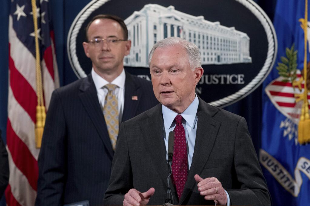 Attorney General Jeff Sessions accompanied by Deputy Attorney General Rod Rosenstein, left, speaks at a news conference to announce an international cybercrime enforcement action at the Department of Justice, Thursday, July 20, 2017, in Washington. (AP Photo/Andrew Harnik)