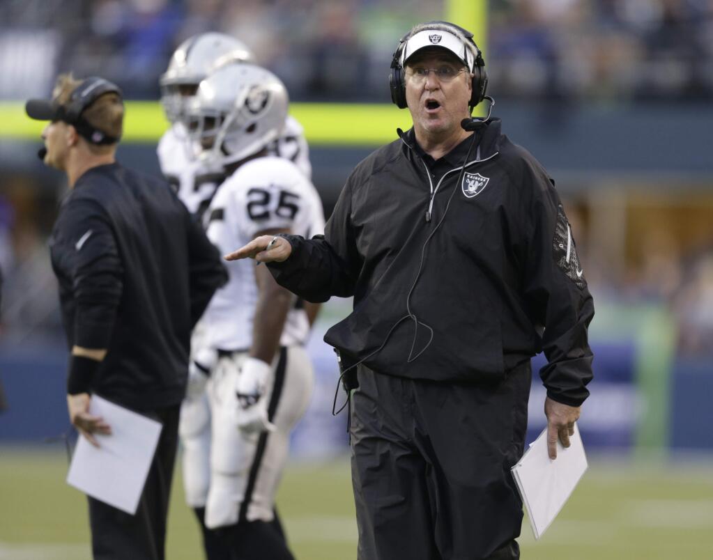 In this Aug. 29, 2013, file photo, Oakland Raiders assistant head coach Tony Sparano calls to his team during an NFL preseason football game against the Seattle Seahawks in Seattle. (AP Photo/Stephen Brashear, File)