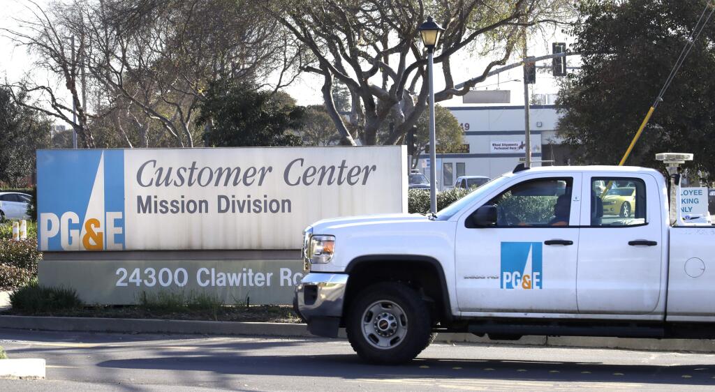 FILE -- In this Wednesday, Jan. 23, 2019, file photo, a Pacific Gas & Electric truck enters their customer center in Hayward, Calif. (AP Photo/Ben Margot, File)
