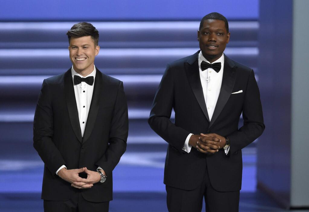 Hosts Colin Jost, left, and Michael Che speak at the 70th Primetime Emmy Awards on Monday, Sept. 17, 2018, at the Microsoft Theater in Los Angeles. (Photo by Chris Pizzello/Invision/AP)