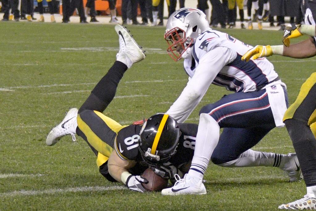 Pittsburgh Steelers tight end Jesse James catches a pass then twists to stretch the ball into the end zone for a touchdown against the New England Patriots with seconds remaining in the fourth quarter in Pittsburgh, Sunday, Dec. 17, 2017. Upon video review, the touchdown call was reversed and the pass was ruled incomplete. The Patriots held on to win 27-24. (AP Photo/Don Wright)