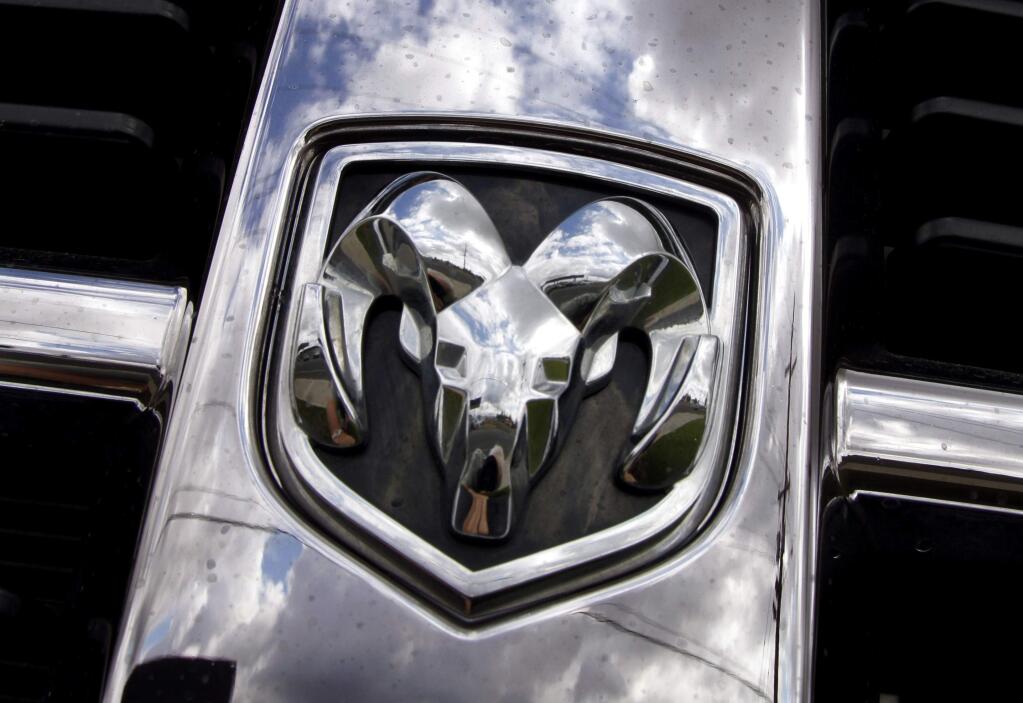 This July 13, 2011, file photo shows the Ram logo on a Ram pickup truck at a dealership in Hillsboro, Ore. Fiat Chrysler will buy back about 500,000 Ram pickup trucks in the biggest such action in U.S. history as part of a deal with U.S. safety regulators to settle legal problems in about two-dozen recalls, two people briefed on the matter say. (AP Photo/Don Ryan, File)