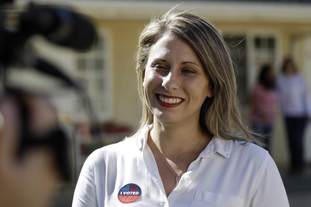FILE - In this Nov. 6, 2018, file photo, Katie Hill speaks during an interview after voting in Agua Dulce, Calif. Hill announced her resignation over the weekend following the publication of explicit photos that outed the relationship. She describes the photos as “revenge porn” and is vowing to fight the problem so that women and girls don't shy away from politics in the future. Hill's resignation in a sex scandal she blamed on an abusive husband has observers wondering if women are held to higher standards in public life and what the future holds for politicians coming of age in the iPhone era. (AP Photo/Marcio Jose Sanchez, File)