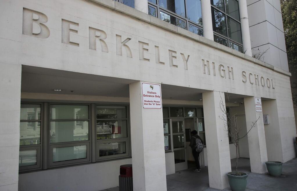 A student walks into Berkeley High School in Berkeley, Calif., Thursday, April 11, 2019. (AP Photo/Jeff Chiu)