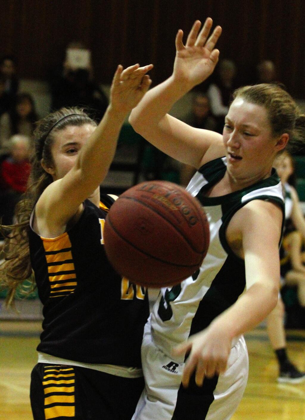 Bill Hoban/Index-TribuneSenior Shelby Camilleri (right) battles for the ball during the Lady Dragons' nonleague victory over Novato Tuesday night in Pfeiffer Gym.