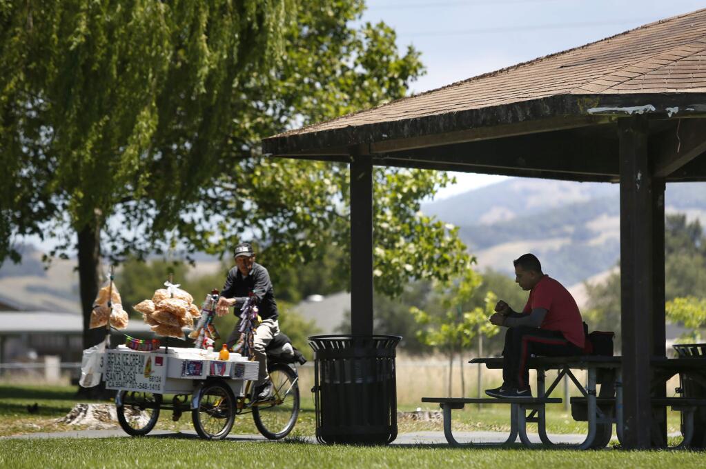 Jimmy Hernandez sits in the shade of a covered picnic gazebo while he eats his lunch and enjoys the weather at Southwest Community Park Sunday, May 27, 2018 in Santa Rosa, California. (BETH SCHLANKER/The Press Democrat)