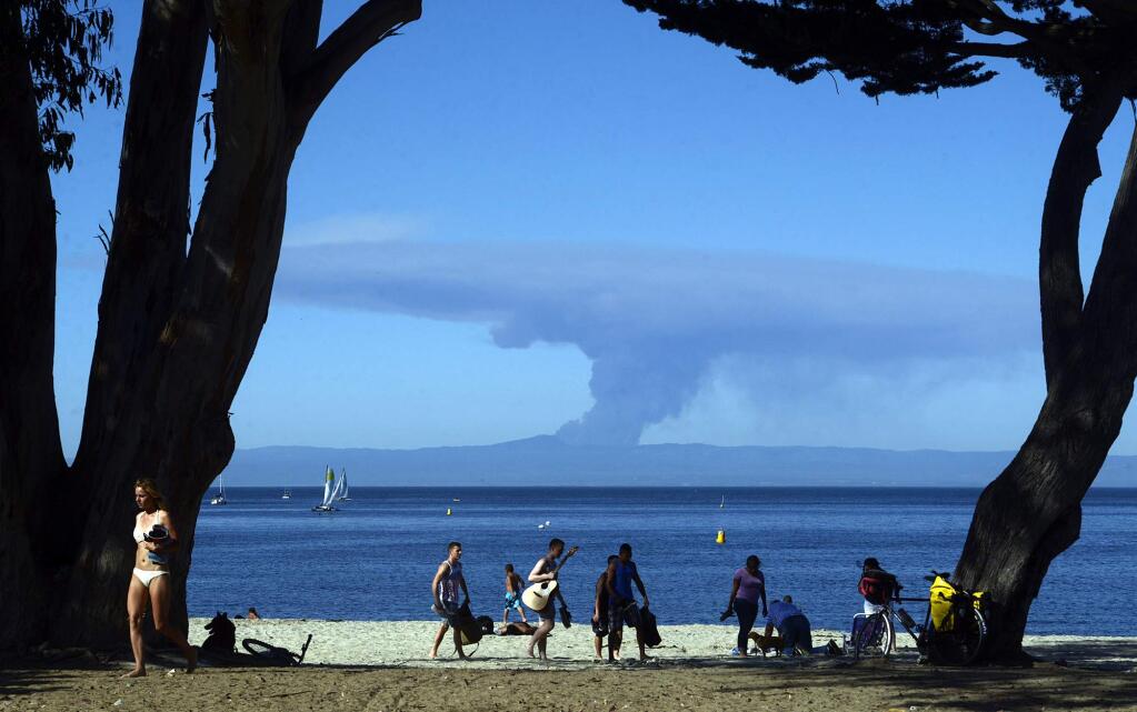 Smoke from the Loma fire on Loma Prieta Mountain in the Santa Cruz Mountains is visible from Window on the Bay Park in Monterey, Calif., on Monday, Sept. 26, 2016. (David Royal/The Monterey County Herald via AP)