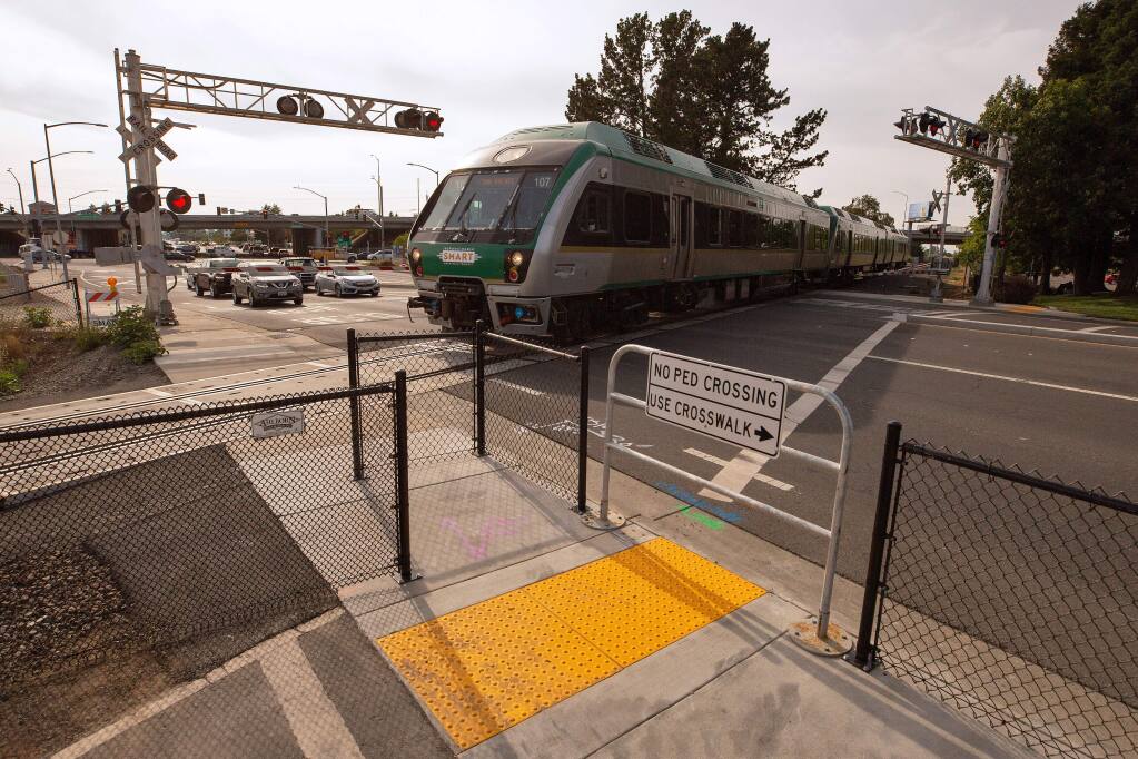 A southbound SMART train passes in front of a newly installed Z gate for pedestrians where Golf Course Drive intersects with the railway in Rohnert Park, California, on Tuesday, July 9, 2019. Two people were killed by SMART trains at this railway intersection in two separate accidents, a day apart. (Alvin Jornada / The Press Democrat)