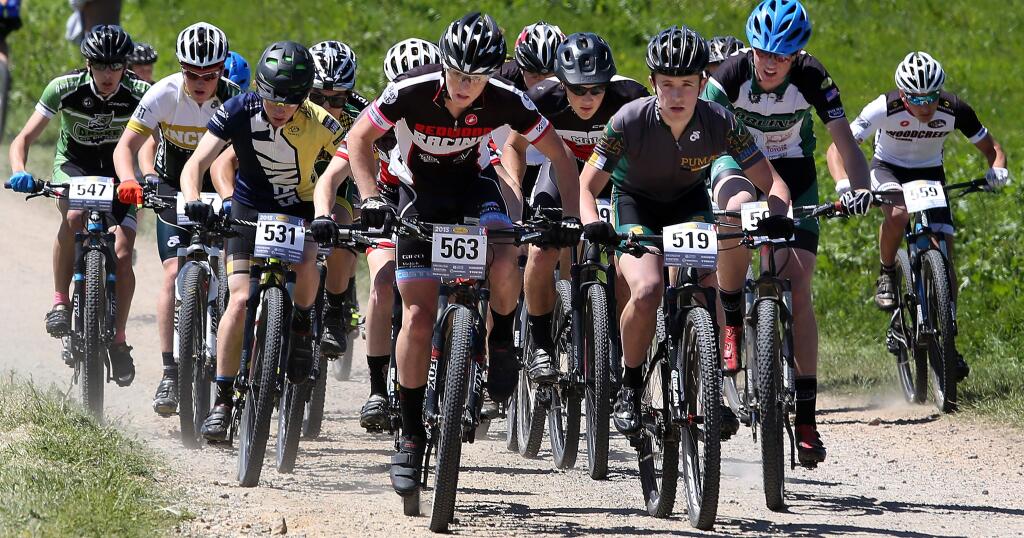 The varsity boys take off on their mountain bikes during the NorCal High School Cycling League's Five Spring Farm Round Up, Saturday, April 11, 2015. (CRISTA JEREMIASON / The Press Democrat)