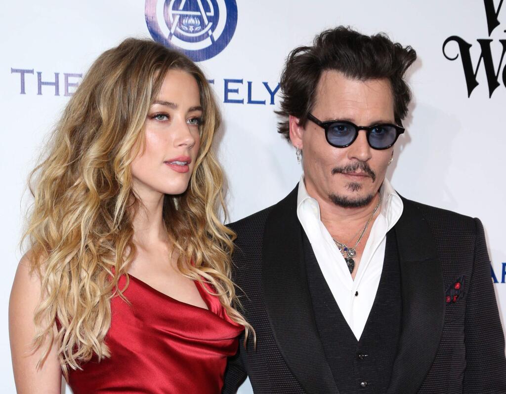 Amber Heard, left, and Johnny Depp arrive at The Art of Elysium's Ninth annual Heaven Gala at 3LABS on Saturday, Jan. 9, 2016, in Culver City, Calif. (Photo by Rich Fury/Invision/AP)