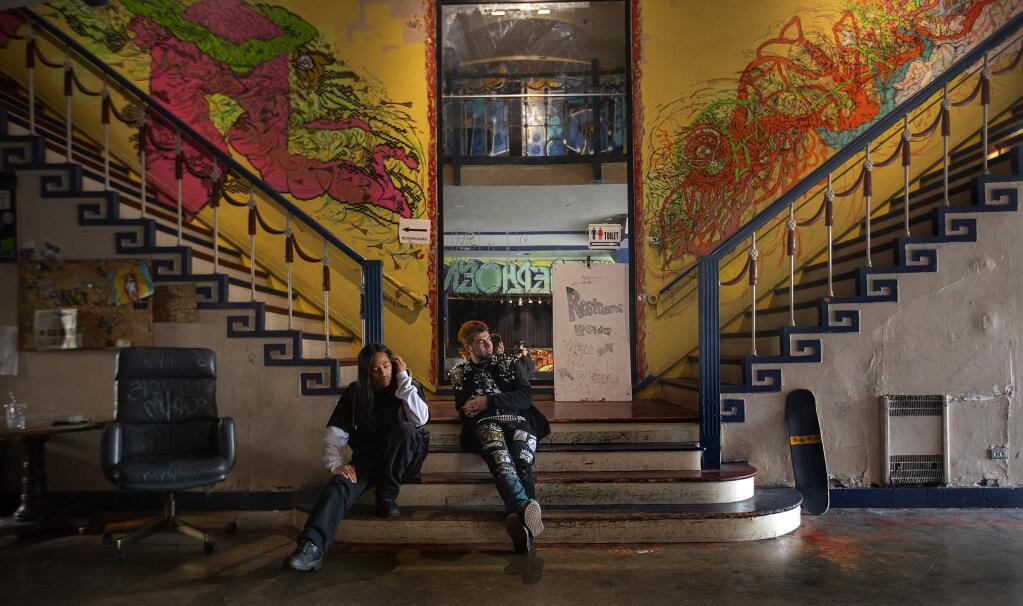 Jowie Montefalcon, left, and Noah Cordova hang out in the front lobby of the Phoenix Theater in downtown Petaluma. The music venue and haven for young teens needs to raise $250,000 for fire sprinklers by April and also needs a costly new roof. (JOHN BURGESS/ PD)