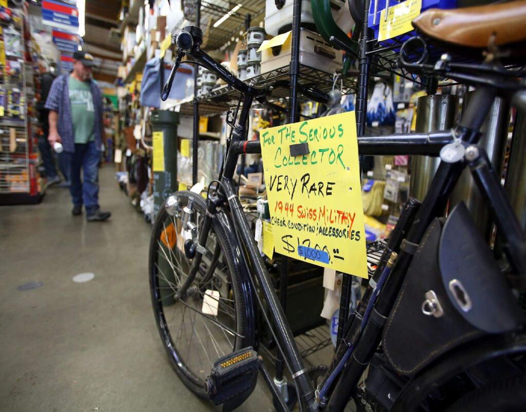 -A Swiss military bike from 1944 stands in the main aisle of the True Value Hardware store in Larkfield. The store has an estimated 1,000 surplus military items for sale, as well as more familiar hardware.