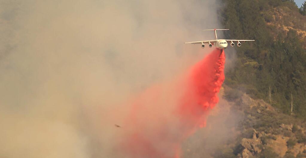 Air tankers are used to corral flames near Ledson Winery in Kenwood, Saturday Oct. 14, 2017. (Kent Porter / The Press Democrat) 2017