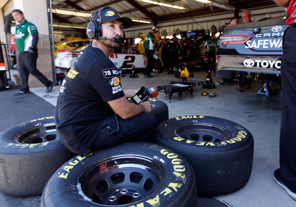 Tommy DiBlasi, a crew member forthe 5-hour Energy Toyota Camry driven by Martin Truex Jr., waits for a signal to attach a set of tires to the car before a practice session for the NASCAR Monster Energy Cup Series Toyota/Save Mart 350 race at Sonoma Raceway on Friday, June 22, 2018. (Alvin Jornada / The Press Democrat)