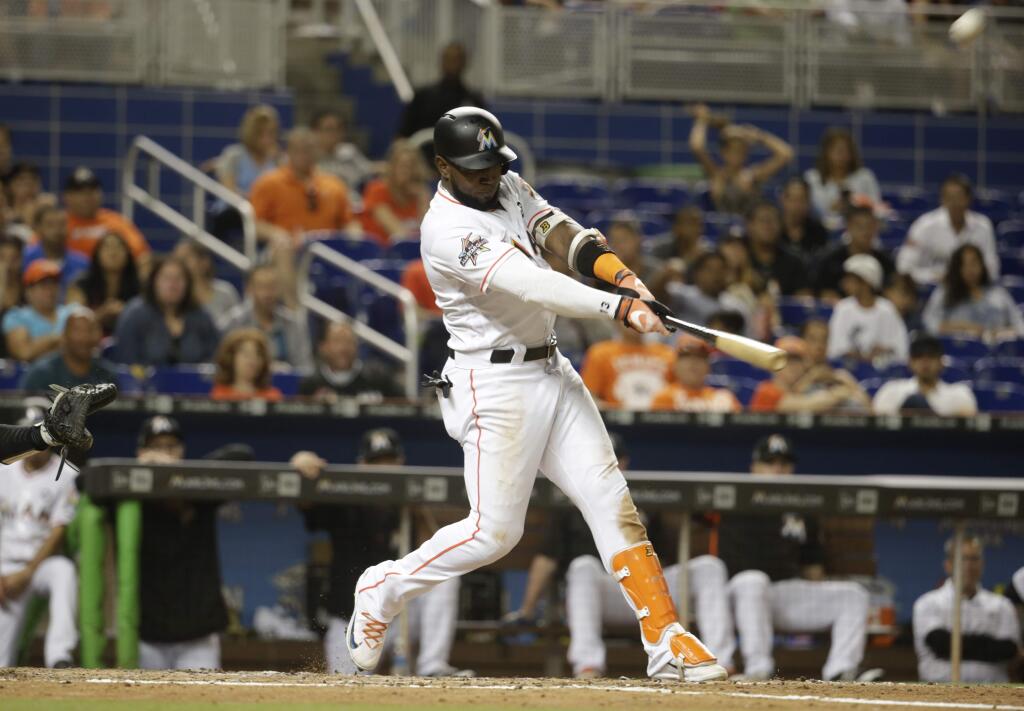 The Miami Marlins' Marcell Ozuna hits a solo home run during the fourth inning against the Oakland Athletics, Tuesday, June 13, 2017, in Miami. (AP Photo/Lynne Sladky)