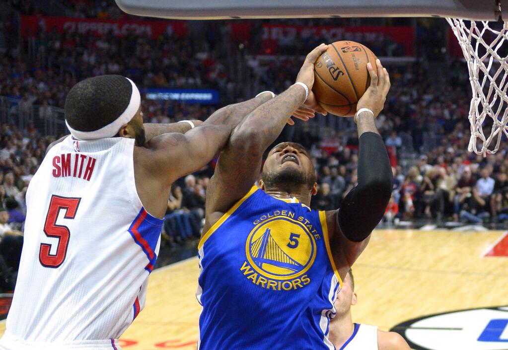 Golden State Warriors center Marreese Speights, right, shoots as Los Angeles Clippers forward Josh Smith defends, Thursday, Nov. 19, 2015, in Los Angeles. (AP Photo/Mark J. Terrill)