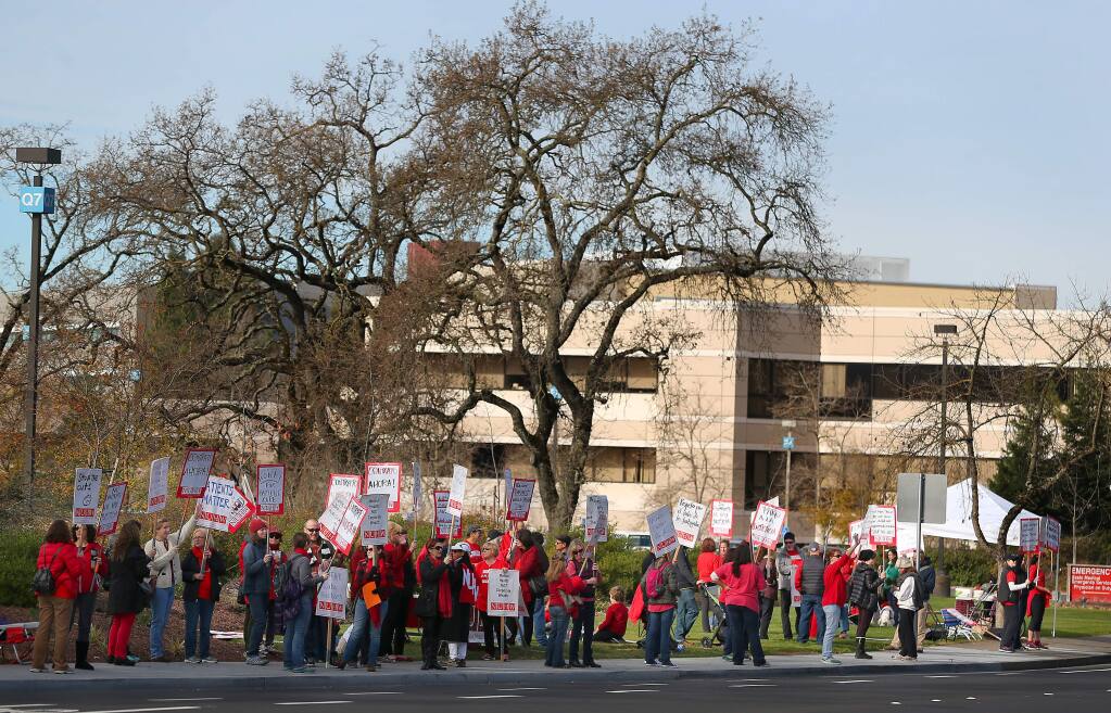 Mental health professionals and their supporters protest in front of Kaiser Permanente in Santa Rosa on Monday, Jan. 12, 2015. (CHRISTOPHER CHUNG/ PD)