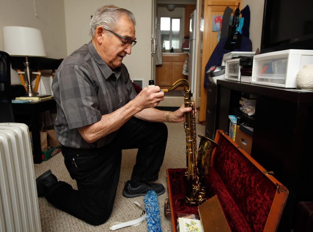 Curtis Smith assembles his saxophone, the only possession he and his wife Ramona took with them as they evacuated their Wikiup neighborhood home before it was destroyed by the Tubbs fire, in Windsor, California, on Friday, March 2, 2018. (Alvin Jornada / The Press Democrat)