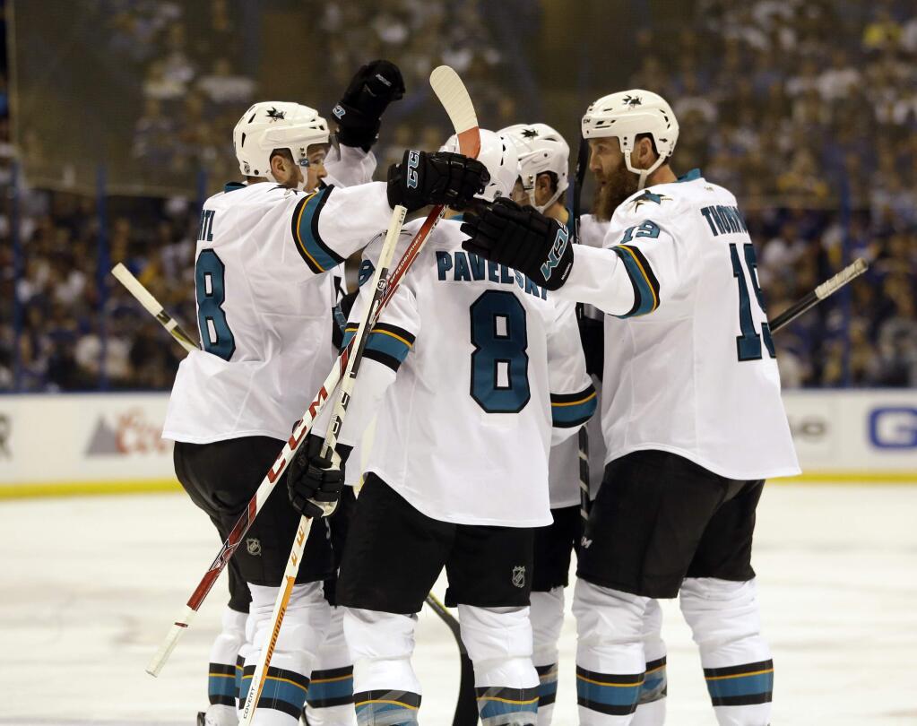 San Jose Sharks center Tomas Hertl, left, celebrates with his teammates after scoring a goal during the first period in Game 5 of the NHL hockey Stanley Cup Western Conference finals against the St. Louis Blues, Monday, May 23, 2016, in St. Louis. (AP Photo/Jeff Roberson)