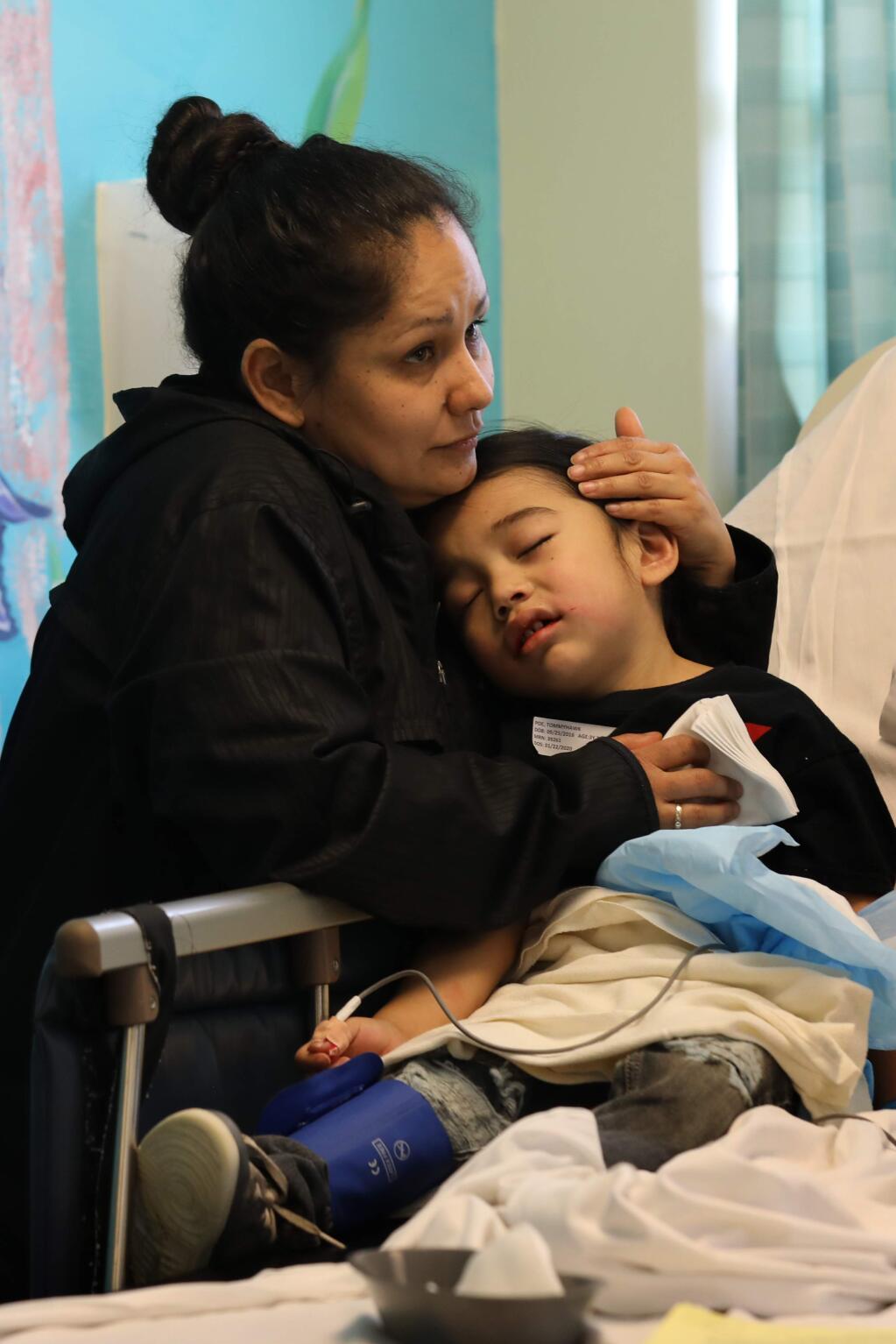 Nicole Ventura comforts her son TommyHawk Poe, 3, while he wakes up after having multiple crowns and tooth extractions at the PDI Surgery Center in Windsor on Wednesday, January 22, 2020. (BETH SCHLANKER/ The Press Democrat)