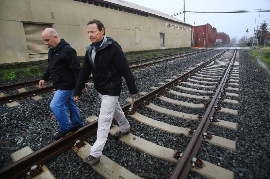 Santa Rosa Police Department Sgt. John Cregan, left and Santa Rosa's Vice Mayor Tom Schwedhelm walk the SMART tracks as the two participate in the Homeless Census Survey, in Santa Rosa, Friday Jan. 29, 2016. Cregan , now a captain, is among the Santa Rosa officials working with Oregon-based White Bird Clinic to implement a new model for policing people having mental health crises. (Kent Porter / Press Democrat) 2016