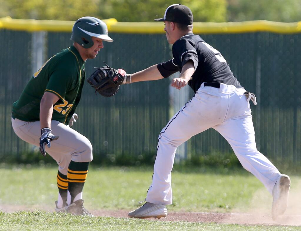 Windsor's Max Brown tags Casa Grande's Joey Markham out at first during the game held at Windsor High School, Wednesday, April 15, 2015. (Crista Jeremiason / The Press Democrat)