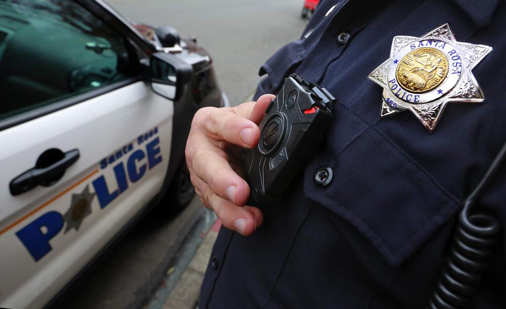 Santa Rosa Police Officer Steve Merical on Tuesday demonstrates Taser's Axon, a video camera he is testing for the department. (Photo by John Burgess /The Press Democrat)