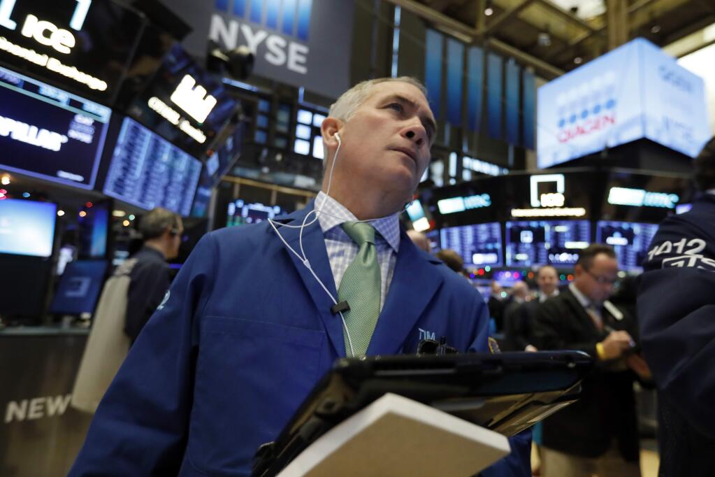 FILE- In this Nov. 29, 2018, file photo trader Timothy Nick works on the floor of the New York Stock Exchange. The U.S. stock market opens at 9:30 a.m. EST on Friday, Dec. 14. (AP Photo/Richard Drew, File)