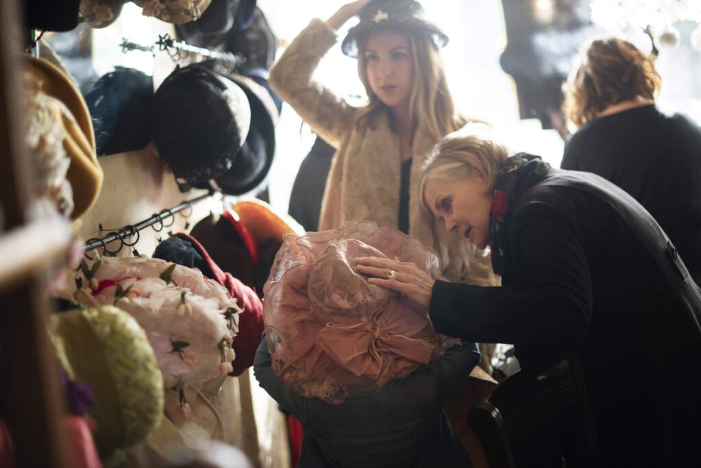 Kathy Negri, right, helping Stella Rose Negri, 5, choose a hat while her mother Liz Negri makes a choice from a large hat collection offered to guests during a Mary Poppins Etiquette Tea Party held Sunday at Tudor Rose English Tea Room in downtown Santa Rosa, California. December 23, 2018.(Photo: Erik Castro/for The Press Democrat)